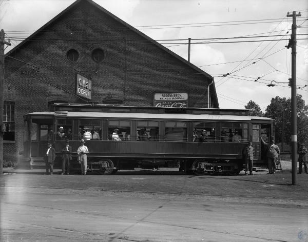 Historic photo of the CM&B depot and a car on layover next to Erie Avenue,