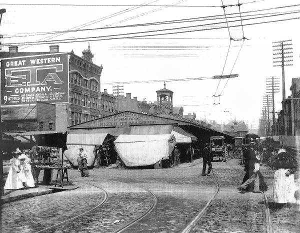 A very old view of the 6th Street Market showing streetcar tracks and the dual overhead wires
