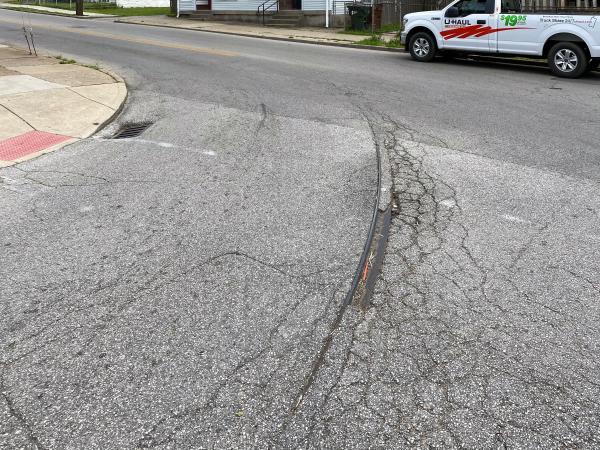 Cracks in the street reveal buried tracks for the start of the Route 5 Holman loop at Holman and 19th Streets in Covington