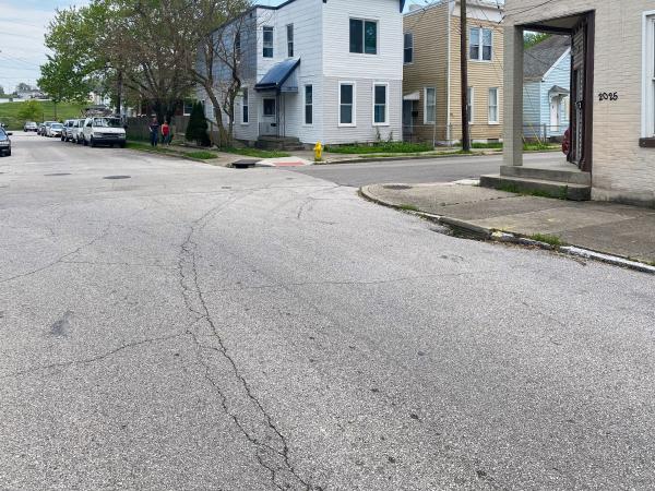 Cracks in the street reveal buried tracks for the Route 5 Holman loop at Russell and 21st Streets in Covington